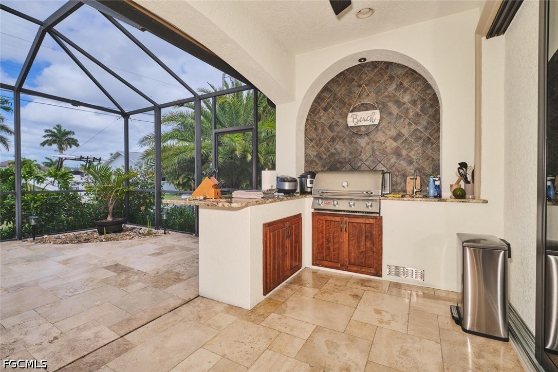 5306 Southwest 27th Place Cape Coral, FL 33914 - Photo 32 of 50 a view of a kitchen with a sink and a stove