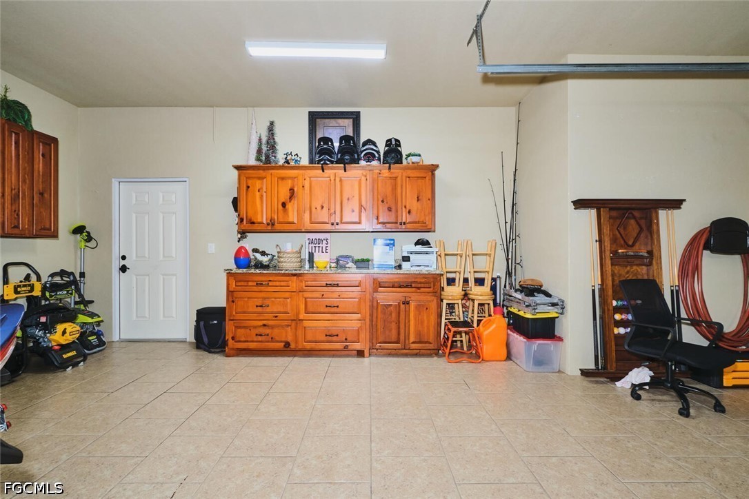 5306 Southwest 27th Place Cape Coral, FL 33914 - Photo 48 of 50 a room with gym equipment and a flat screen tv