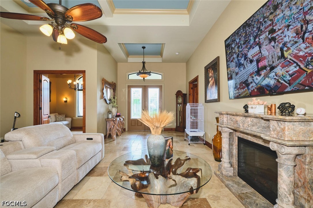 5306 Southwest 27th Place Cape Coral, FL 33914 - Photo 5 of 50 a living room with furniture a fireplace and a chandelier