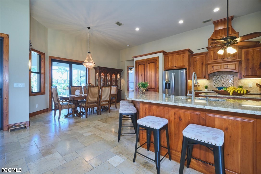 5306 Southwest 27th Place Cape Coral, FL 33914 - Photo 7 of 50 a kitchen with stainless steel appliances granite countertop table chairs sink and cabinets