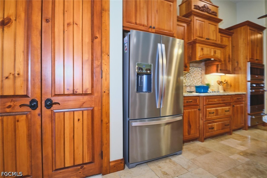 5306 Southwest 27th Place Cape Coral, FL 33914 - Photo 10 of 50 a kitchen with stainless steel appliances a refrigerator and cabinets