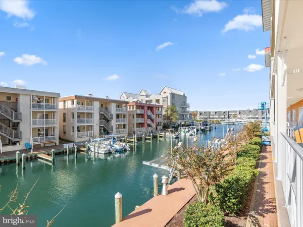 a view of ocean with boats and trees in the background