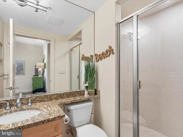 an aerial view of a city with ocean view in back