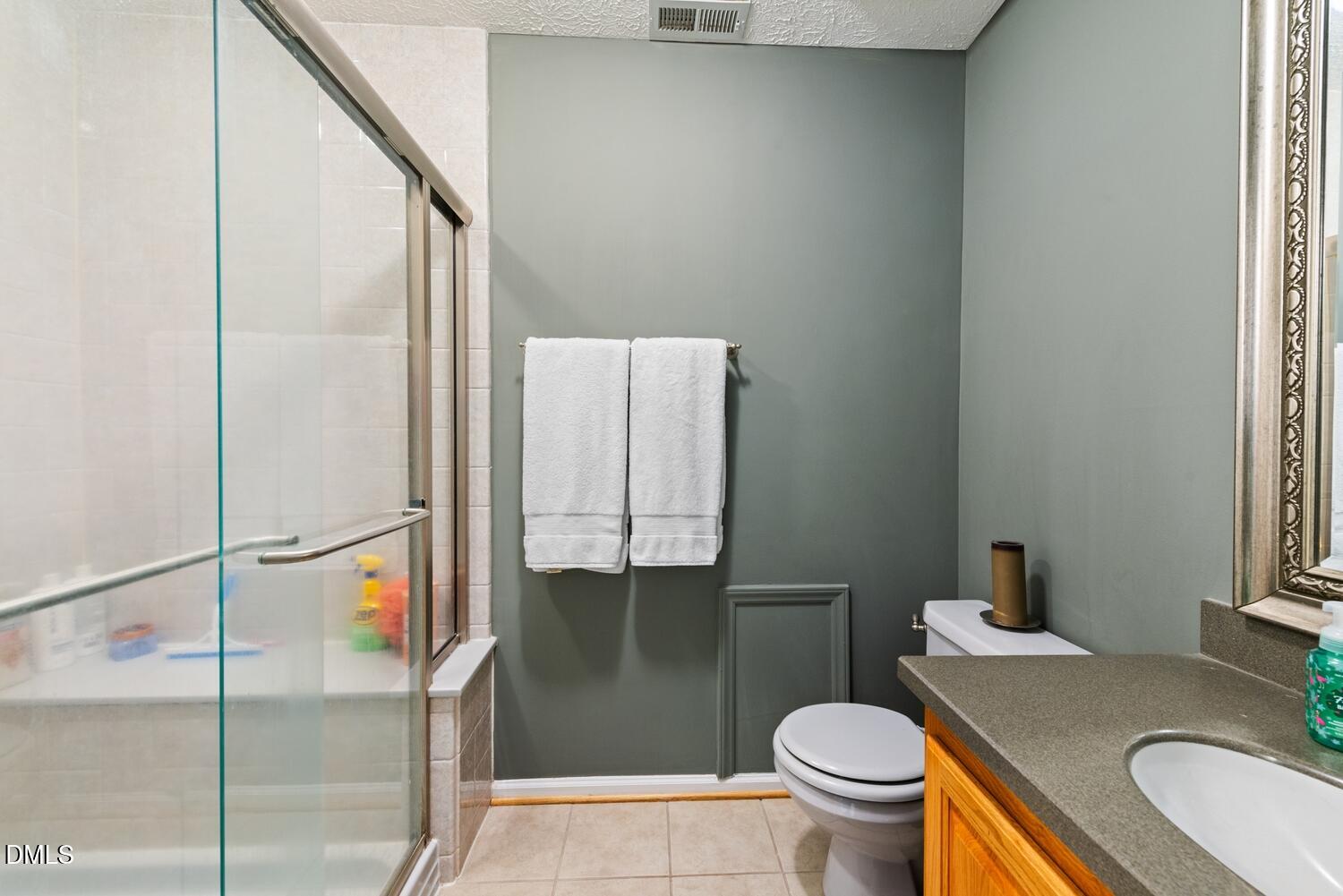 1832 Jimmie Kerr Road Haw River, NC 27258 - Photo 23 of 39 a bathroom with a granite countertop toilet and a sink