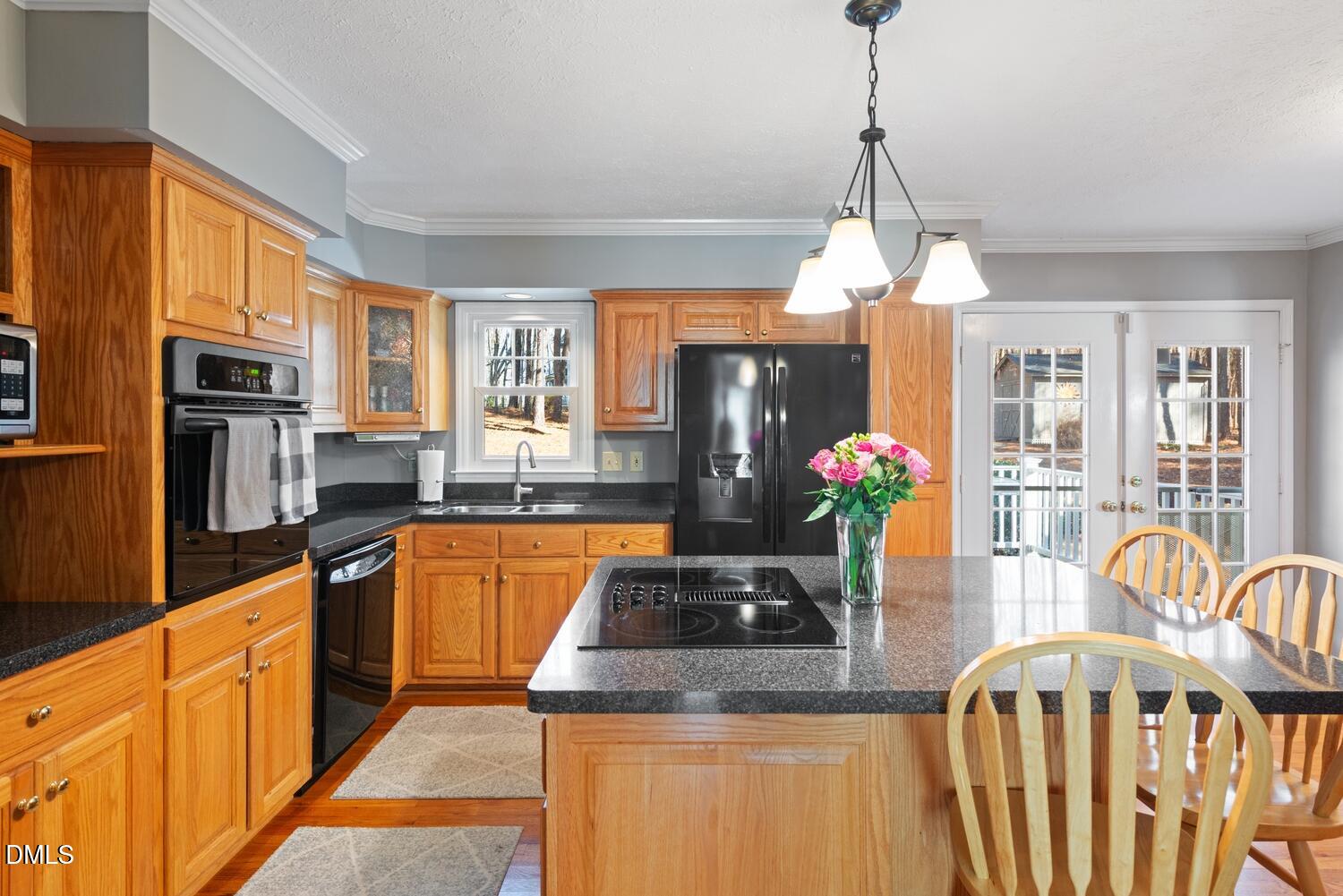 1832 Jimmie Kerr Road Haw River, NC 27258 - Photo 8 of 39 a kitchen with stainless steel appliances granite countertop a kitchen island hardwood floor sink stove dining table and chairs