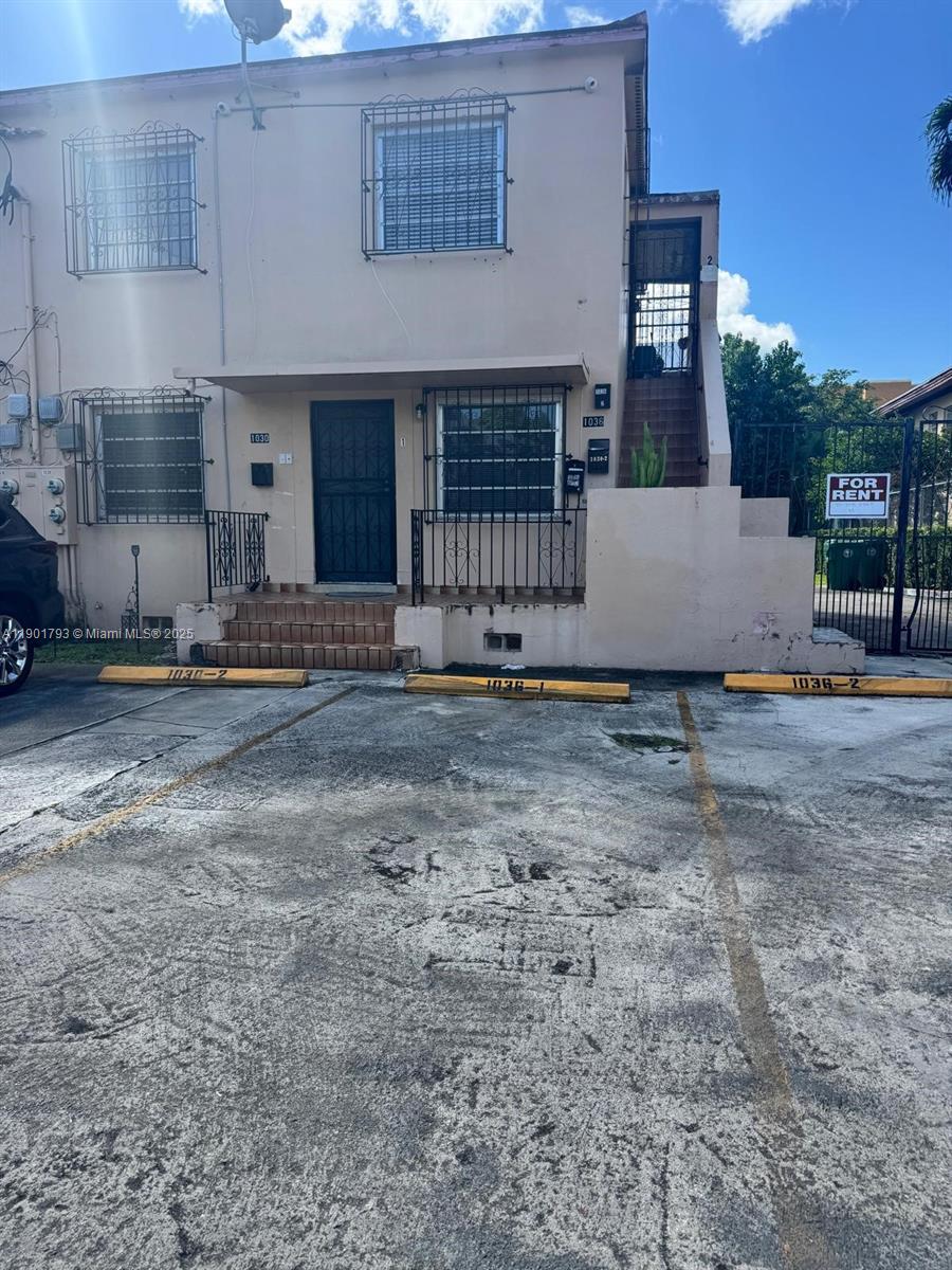 1036 Northwest 3rd Street, Unit 1 Miami, FL 33128 - Photo 1 of 22 a front view of a house with a yard