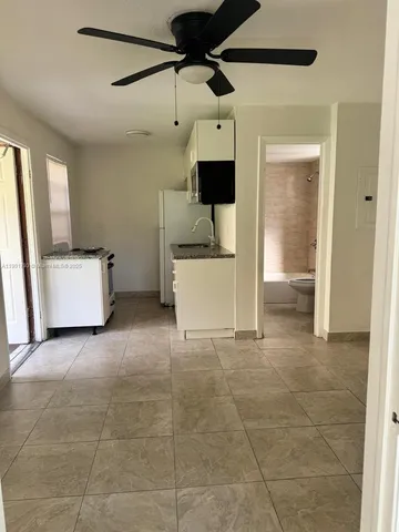 a view of a storage & utility room with a sink