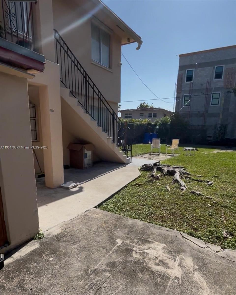1036 Northwest 3rd Street, Unit 1 Miami, FL 33128 - Photo 7 of 22 a view of a house with a yard