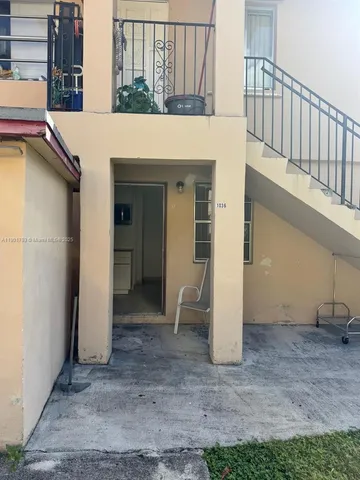 a view of a patio with table and chairs