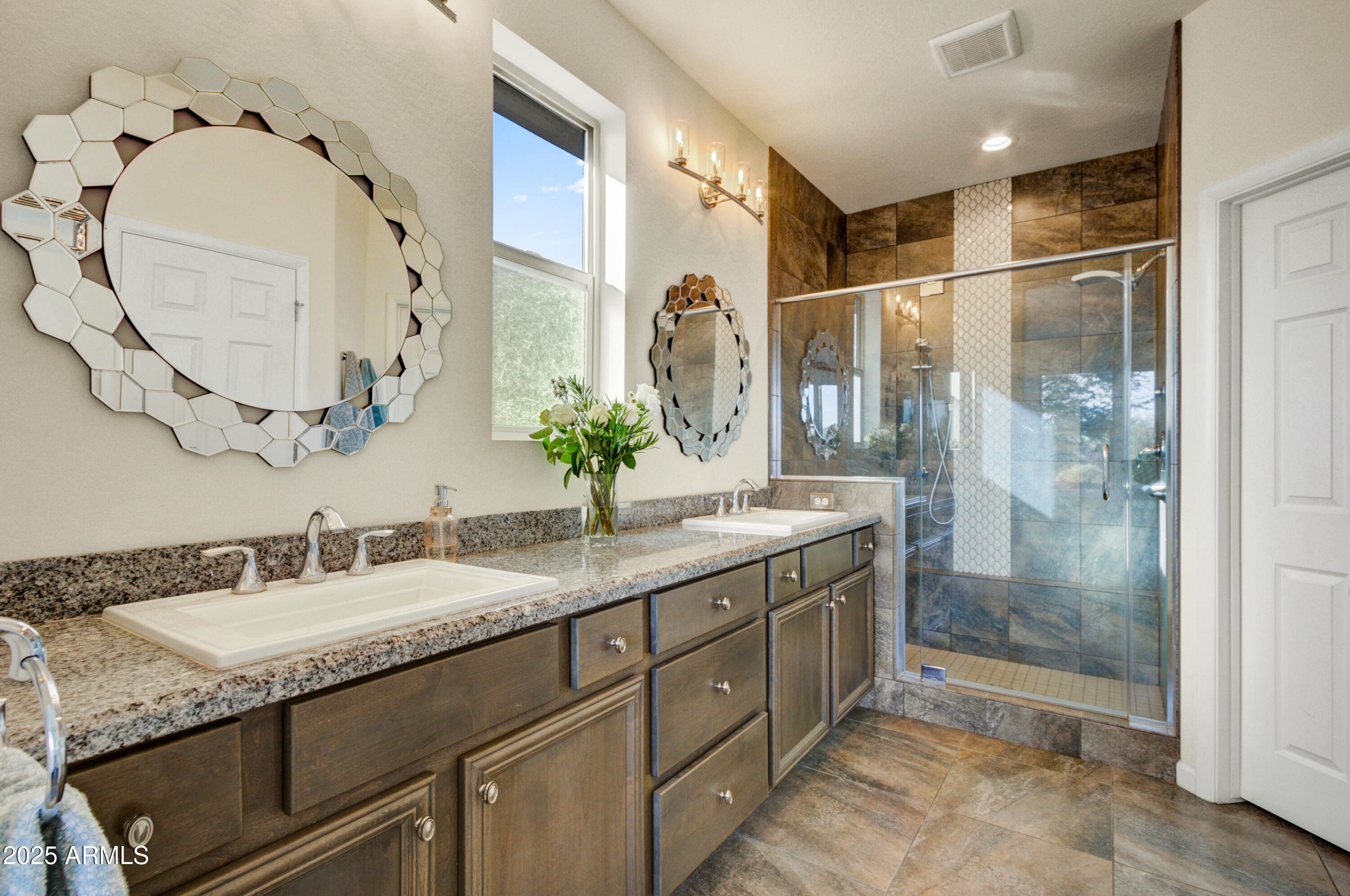 17919 East Slide Rock Drive Rio Verde, AZ 85263 - Photo 17 of 48 a bathroom with a granite countertop sink a mirror and a shower