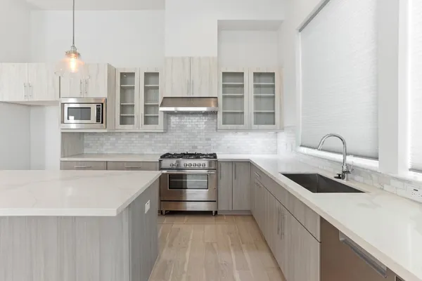 a kitchen with a sink stove and cabinets
