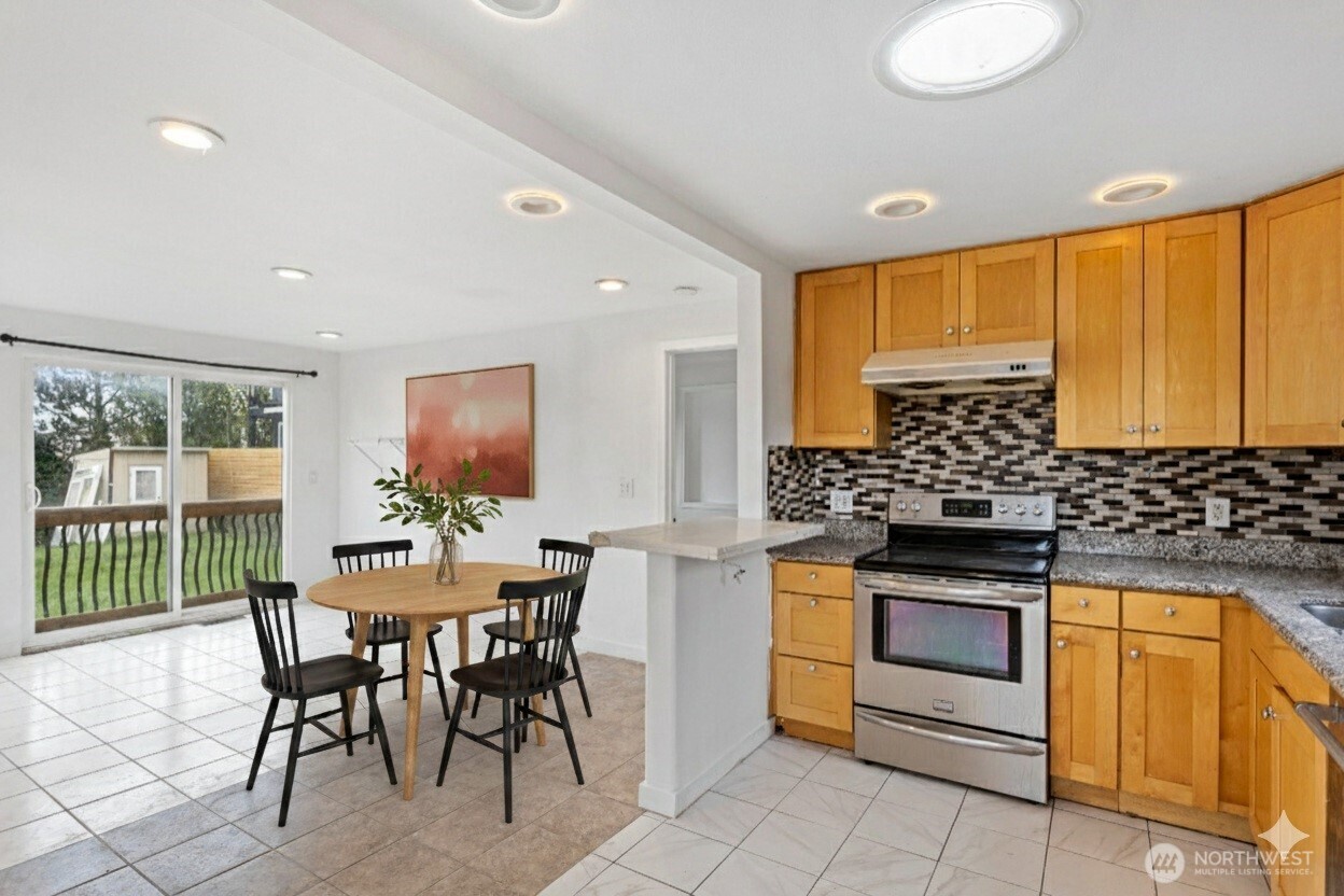 1901 South Plum Street Seattle, WA 98144 - Photo 5 of 14 a kitchen with stainless steel appliances granite countertop a stove a sink and a microwave