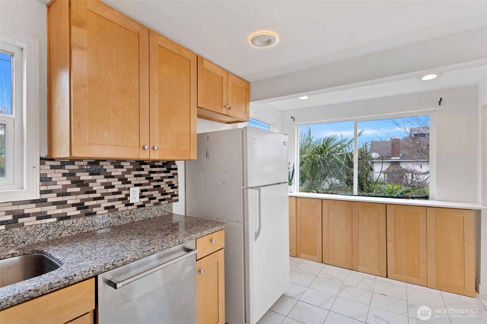 1901 South Plum Street Seattle, WA 98144 - Photo 6 of 14 a kitchen with stainless steel appliances granite countertop a refrigerator and a sink