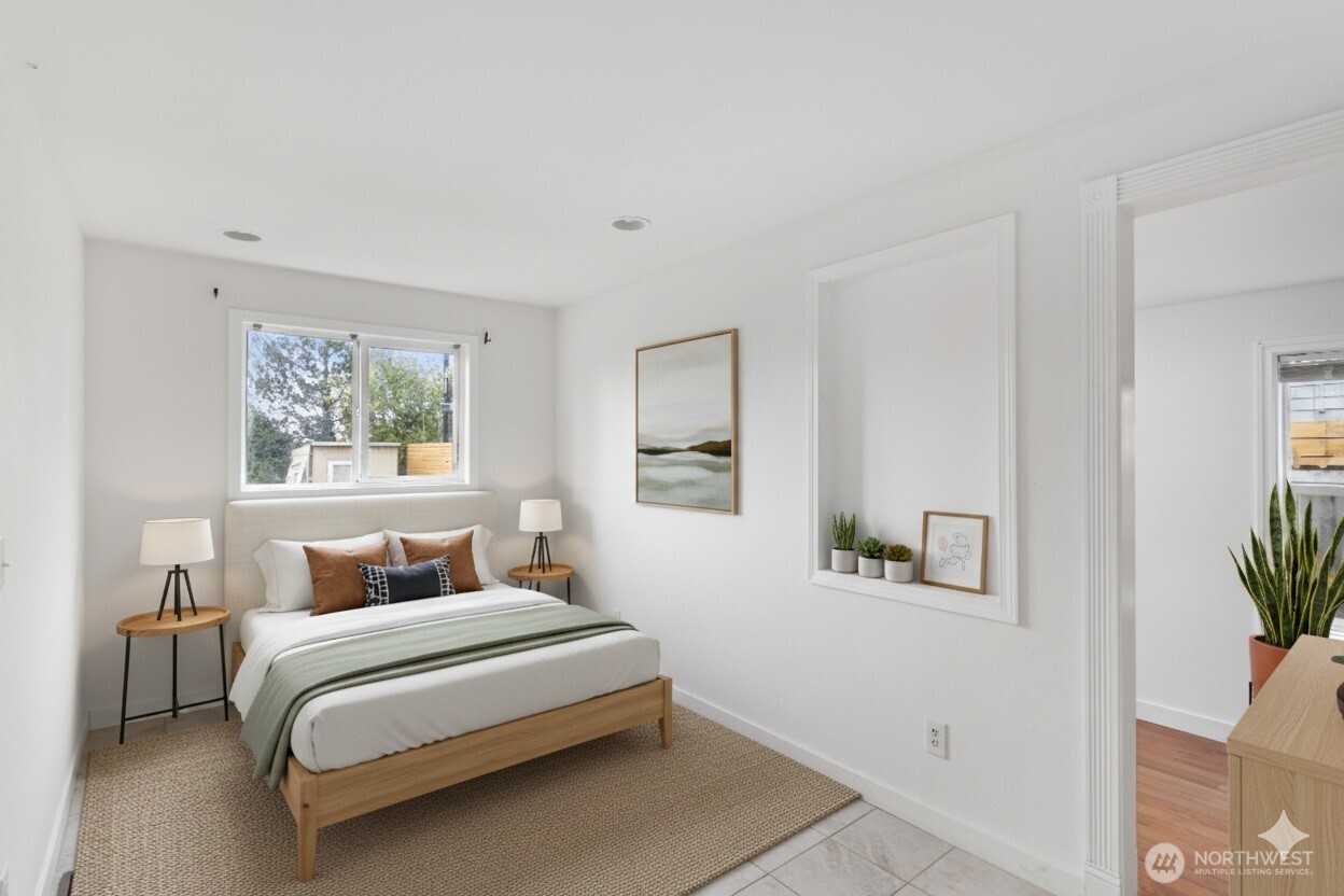 1901 South Plum Street Seattle, WA 98144 - Photo 7 of 14 a bedroom with a large bed and a potted plant