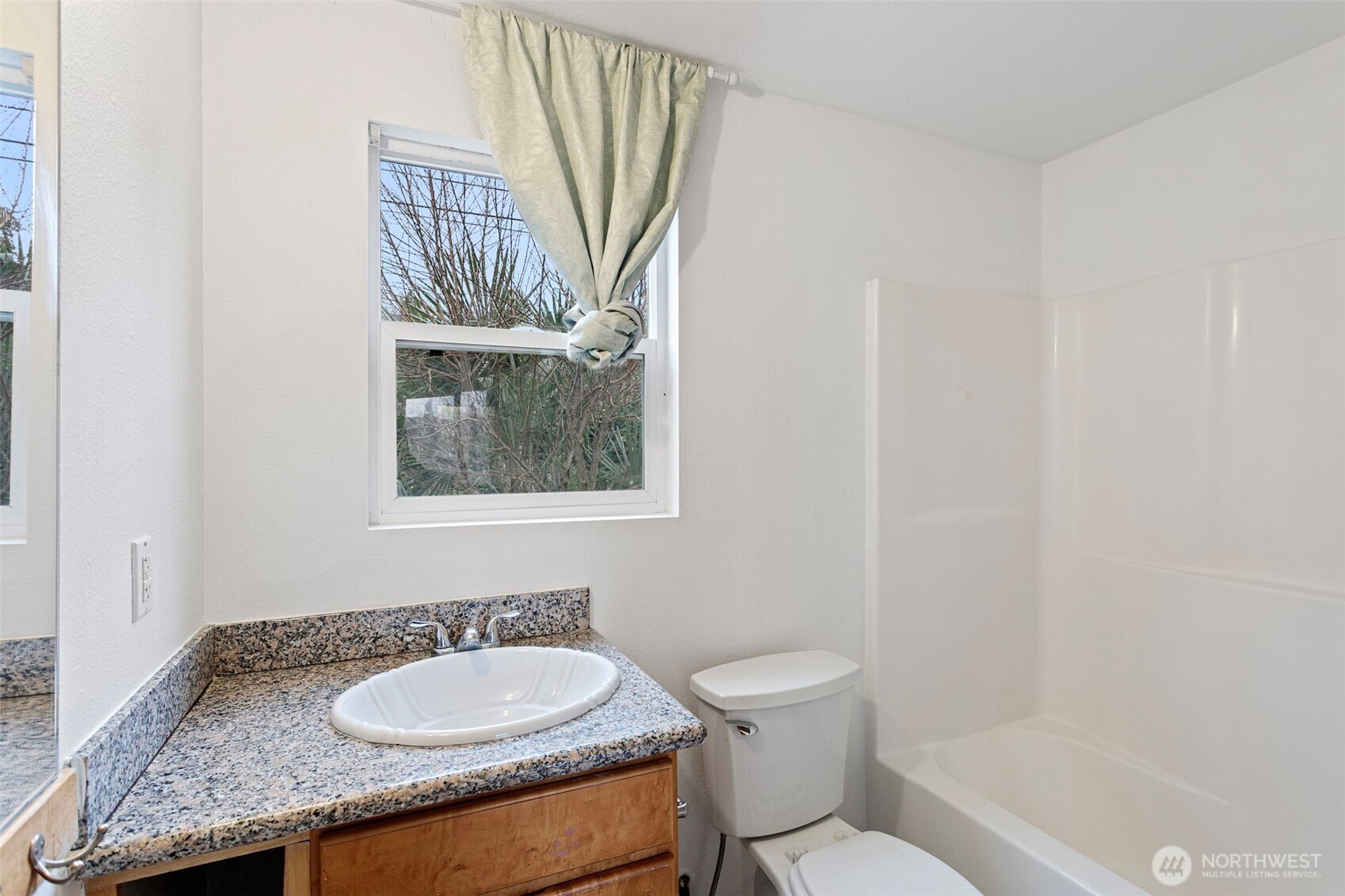 1901 South Plum Street Seattle, WA 98144 - Photo 9 of 14 a bathroom with a granite countertop toilet a sink and a mirror