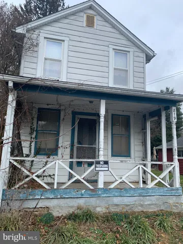 a view of house with wooden deck