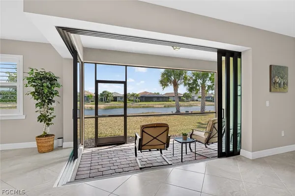 a living room with a floor to ceiling window and a table