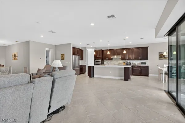 a large white kitchen with stainless steel appliances lots of white cabinets