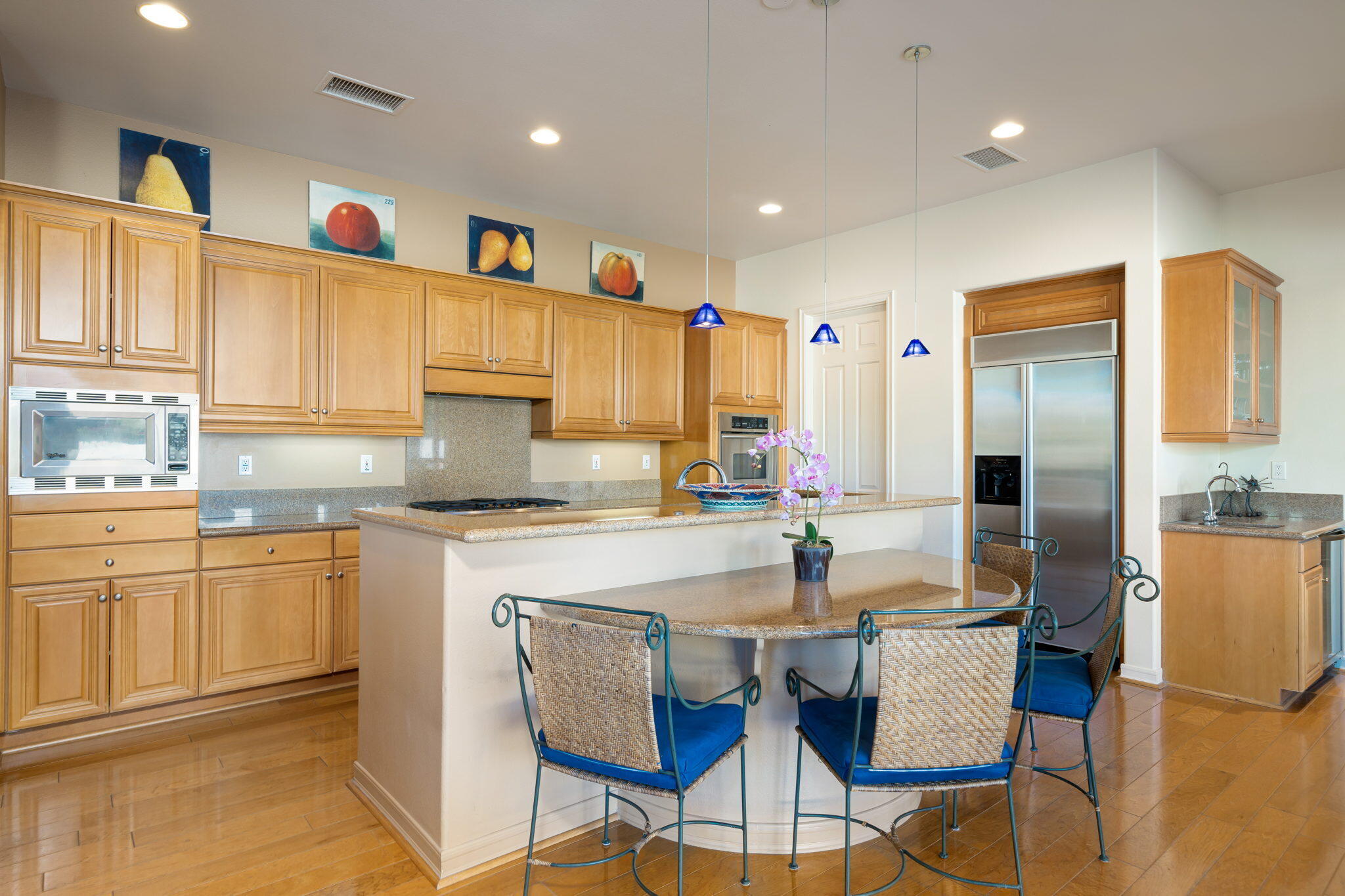 372 Loch Lomond Road Rancho Mirage, CA 92270 - Photo 14 of 51 a kitchen with stainless steel appliances granite countertop a dining table chairs sink and cabinets