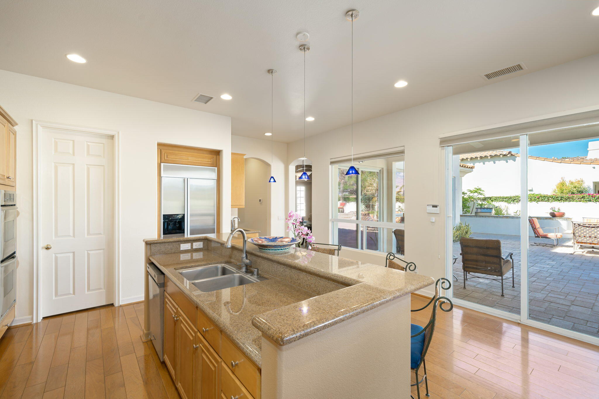 372 Loch Lomond Road Rancho Mirage, CA 92270 - Photo 15 of 51 a kitchen with a sink stove and wooden floor