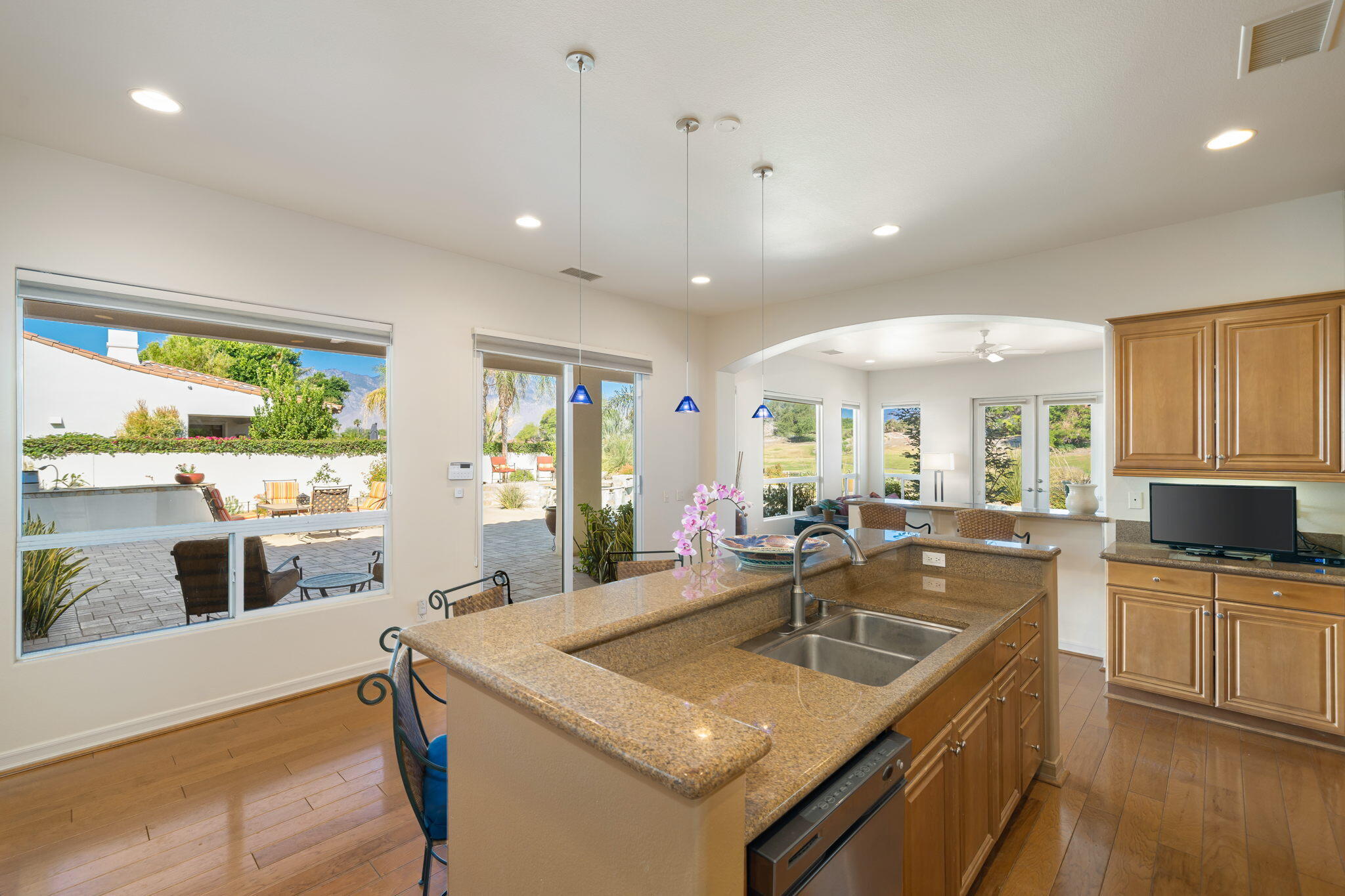 372 Loch Lomond Road Rancho Mirage, CA 92270 - Photo 16 of 51 a kitchen with stainless steel appliances granite countertop sink stove and large window