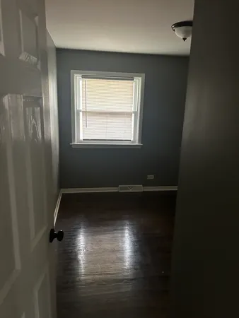 a view of room with window and hardwood floor