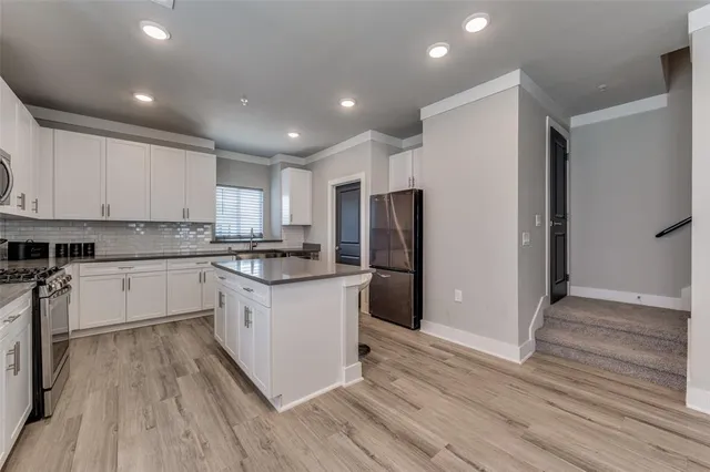 a kitchen with stainless steel appliances granite countertop a refrigerator sink and cabinets