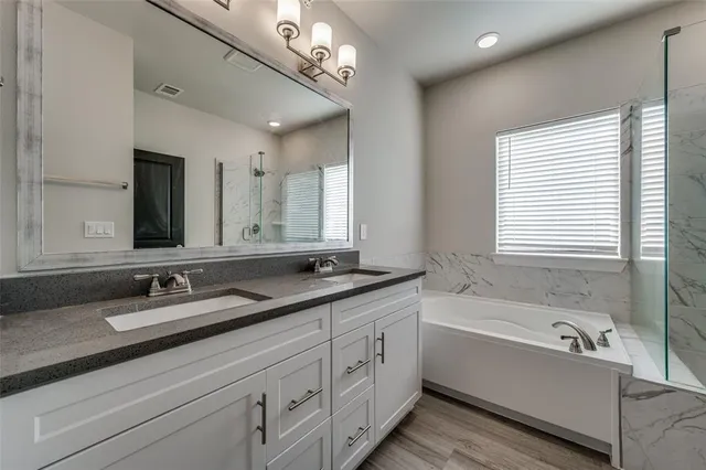a bathroom with a bathtub and a shower