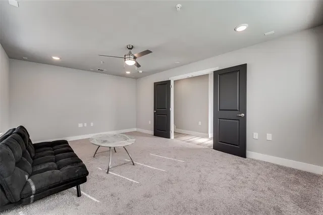 a living room with furniture and a ceiling fan