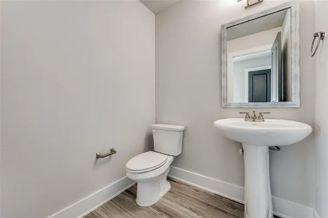 a bathroom with a sink toilet and a mirror