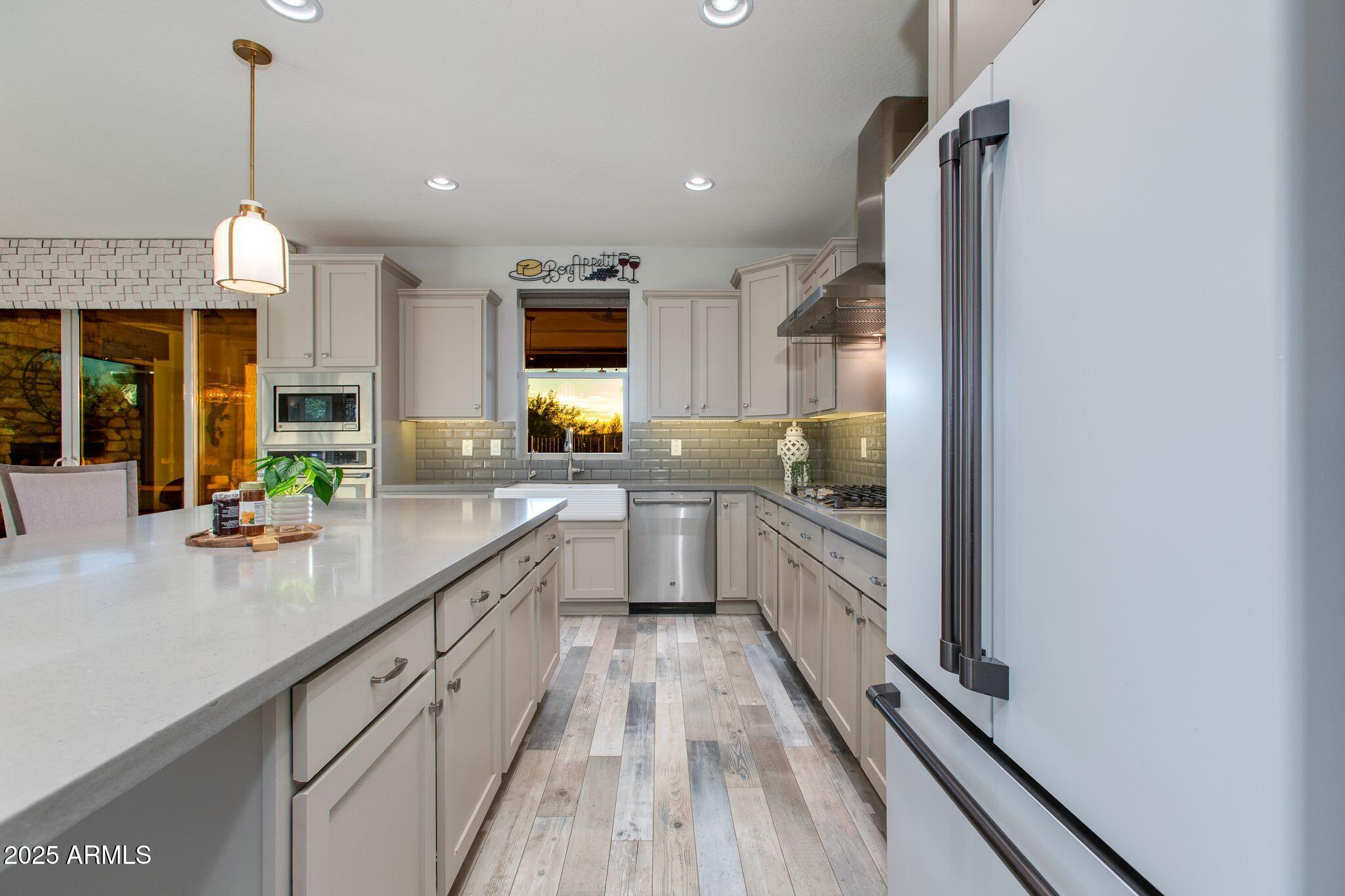 3800 Gold Ridge Road Wickenburg, AZ 85390 - Photo 14 of 51 a large kitchen with kitchen island granite countertop a large counter top a sink and stainless steel appliances
