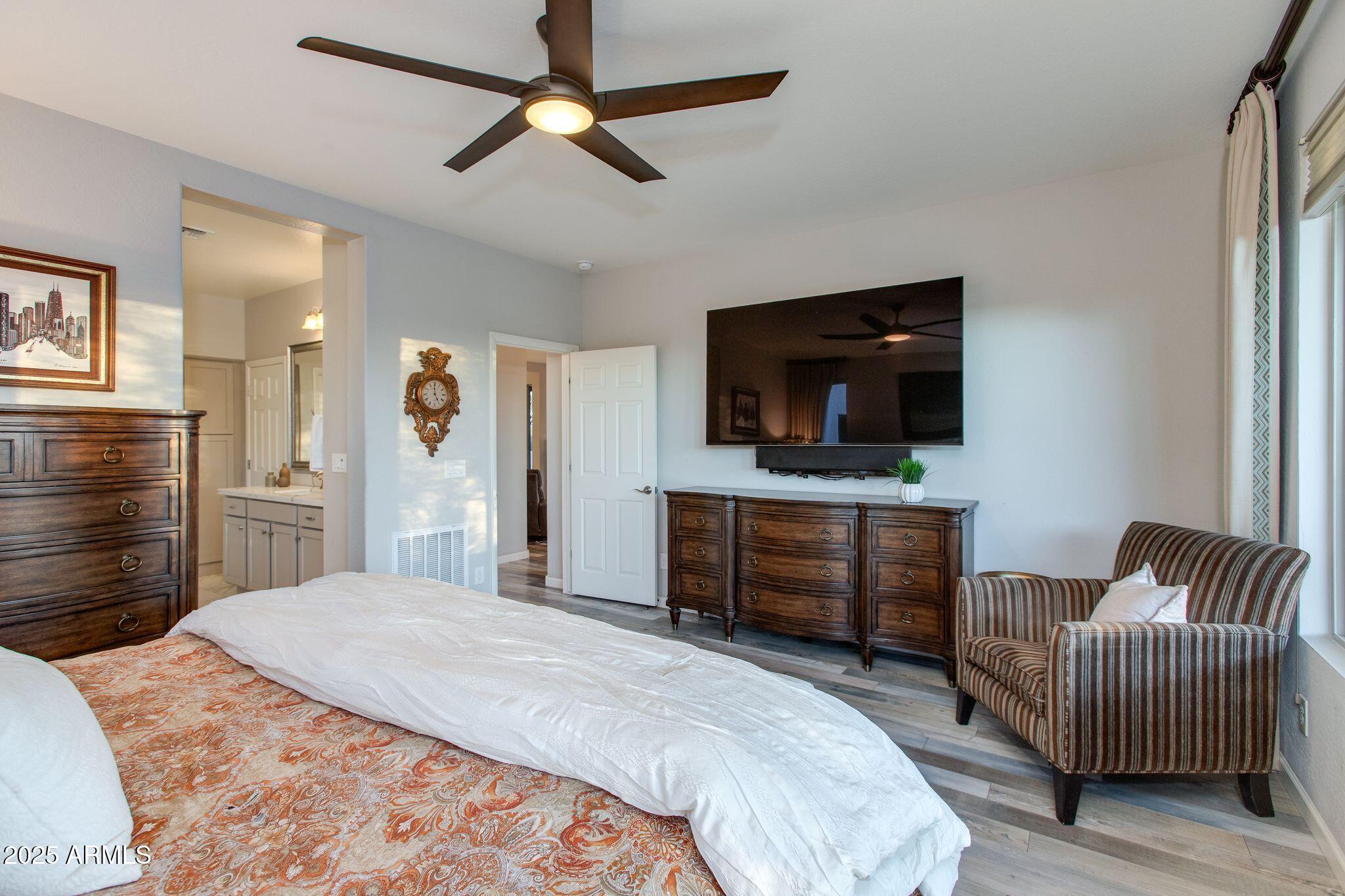 3800 Gold Ridge Road Wickenburg, AZ 85390 - Photo 24 of 51 a bedroom with a bed and a flat screen tv
