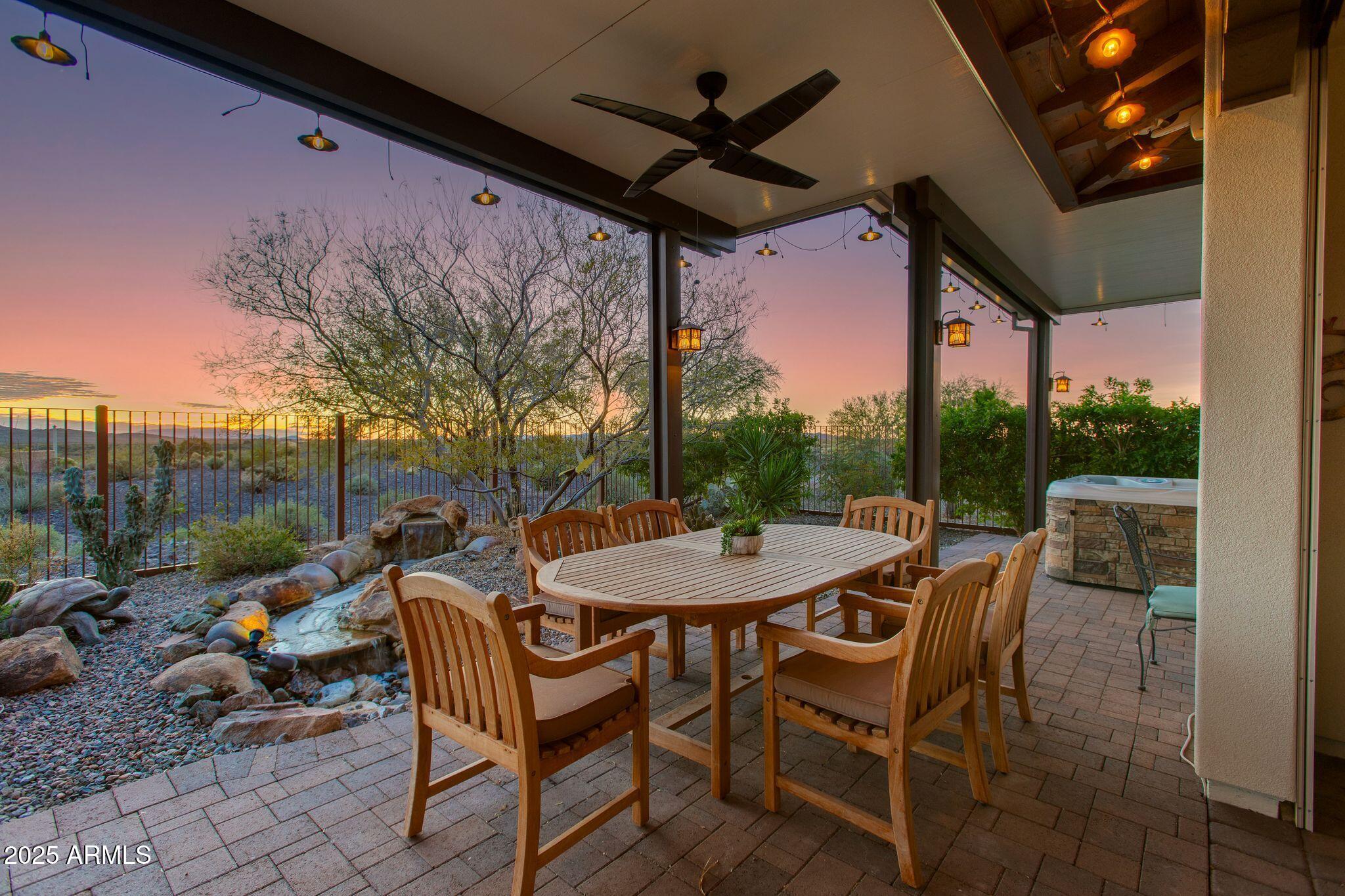 3800 Gold Ridge Road Wickenburg, AZ 85390 - Photo 34 of 51 a view of a patio with a table chairs and a floor to ceiling window