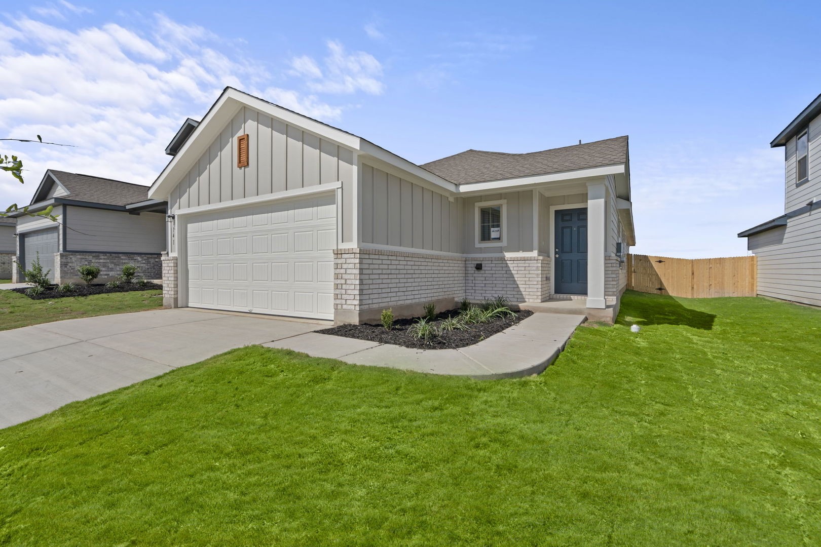 141 Hatari Trail Jarrell, TX 76537 - Photo 2 of 36 a front view of a house with a yard and garage