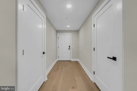 a view of a hallway with wooden floor