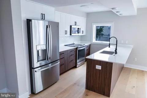 a kitchen with stainless steel appliances a refrigerator and a sink