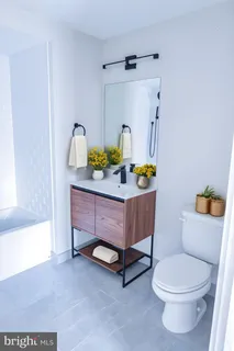 a bathroom with a sink toilet and tub
