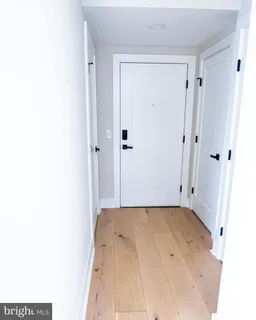 a view of a room with a white wall