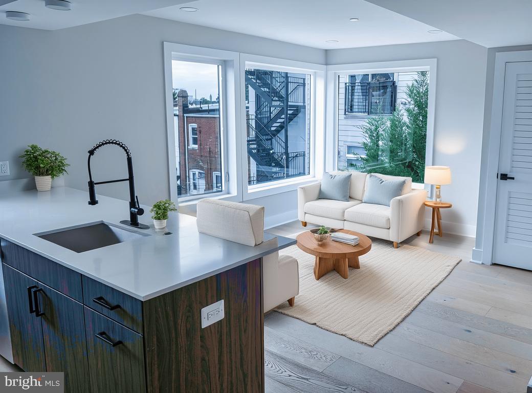 919 12th Street Northeast, Unit A301 Washington, DC 20002 - Photo 4 of 28 a living room with furniture and large windows