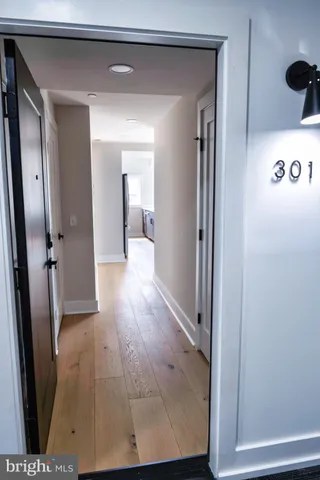 a view of a hallway with wooden floor