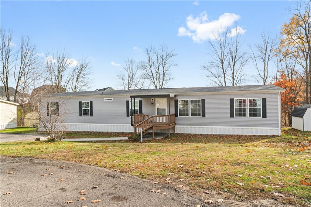 a front view of house with yard and swimming pool