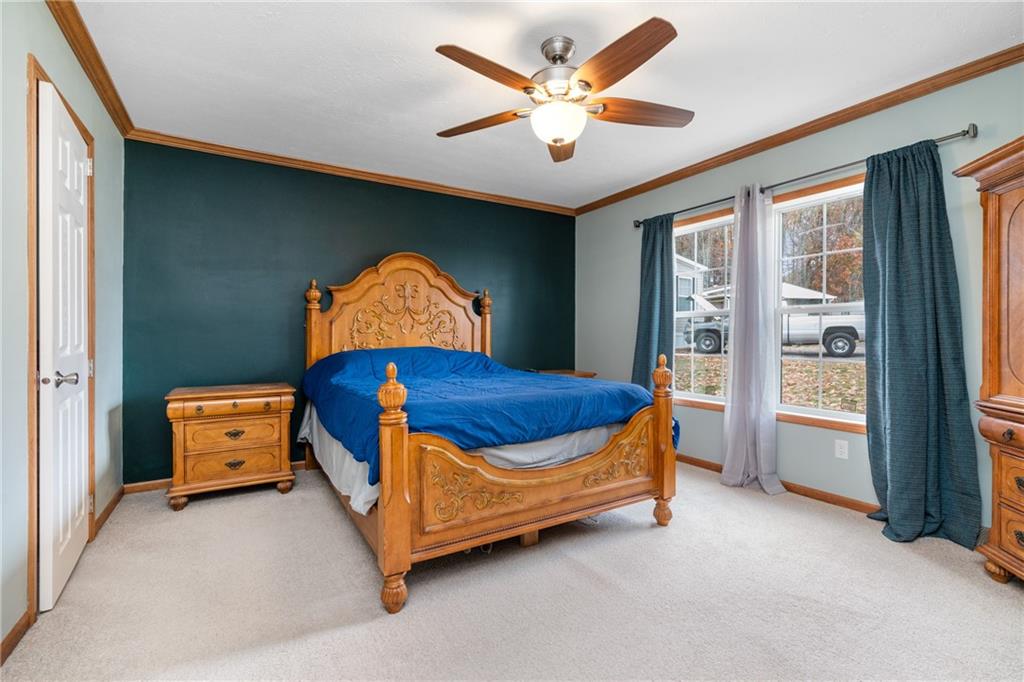 743 Slate Avenue Cranberry Township, PA 16066 - Photo 16 of 32 a bedroom with a bed and a chandelier