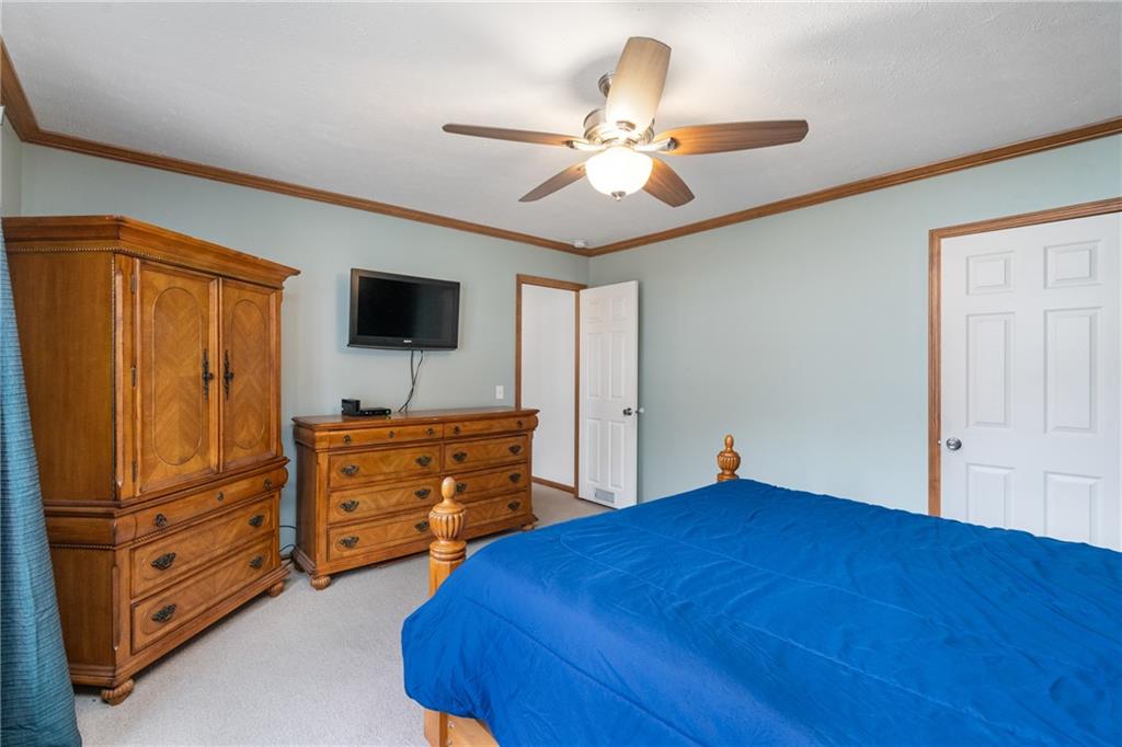 743 Slate Avenue Cranberry Township, PA 16066 - Photo 17 of 32 a bedroom with a bed and a flat tv screen on dresser