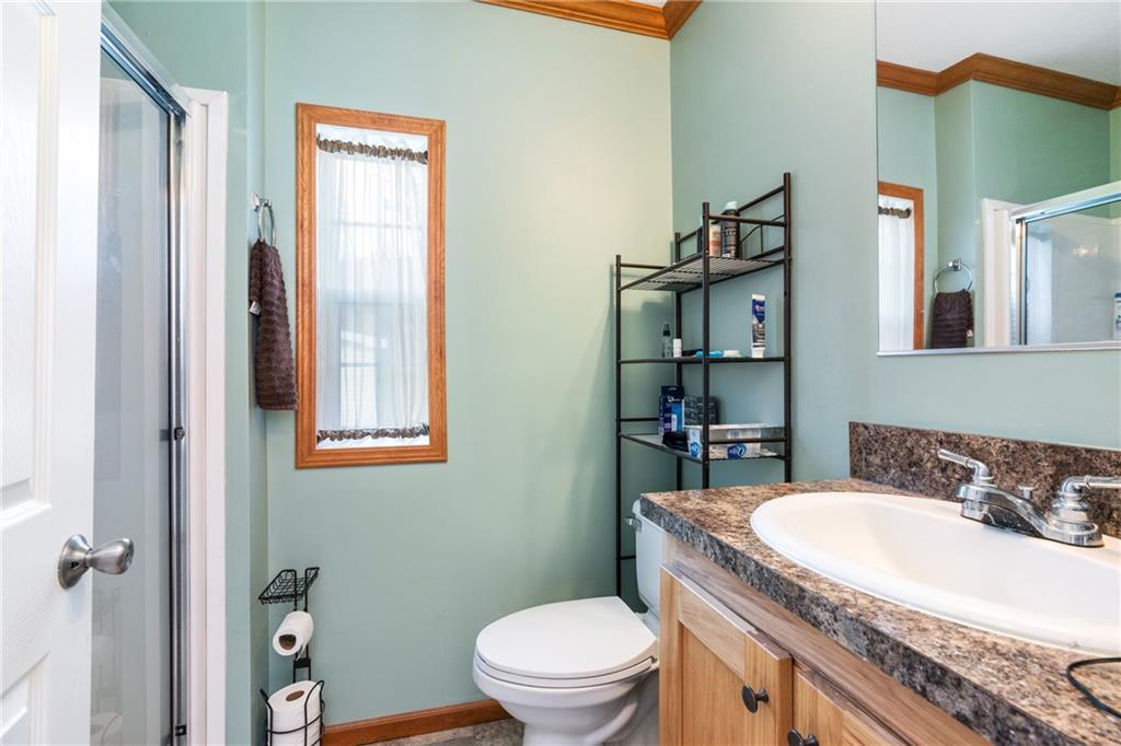 743 Slate Avenue Cranberry Township, PA 16066 - Photo 26 of 32 a bathroom with a granite countertop sink a toilet and a mirror