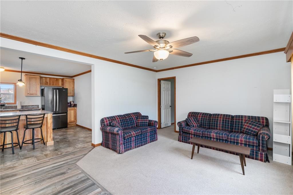 743 Slate Avenue Cranberry Township, PA 16066 - Photo 6 of 32 a living room with furniture a ceiling fan and a rug