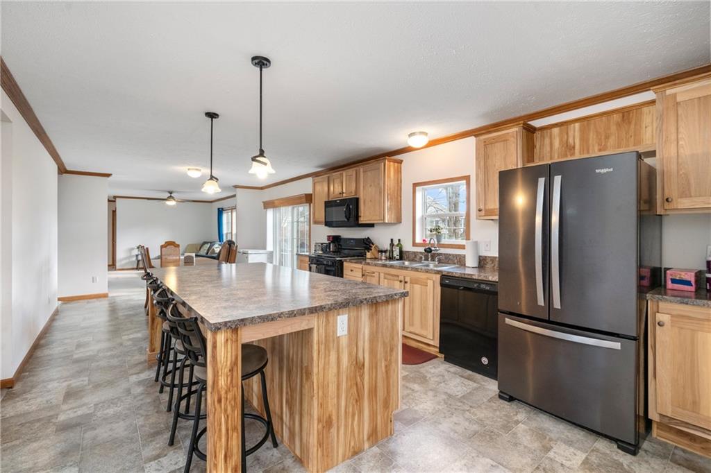 743 Slate Avenue Cranberry Township, PA 16066 - Photo 7 of 32 a kitchen with stainless steel appliances granite countertop a refrigerator a sink a stove and a refrigerator