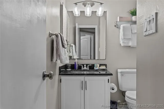 a bathroom with a toilet sink and mirror