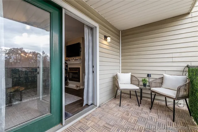 a balcony with table and chairs