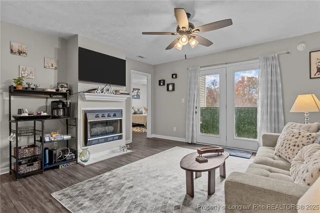 a living room with furniture a flat screen tv and a fireplace