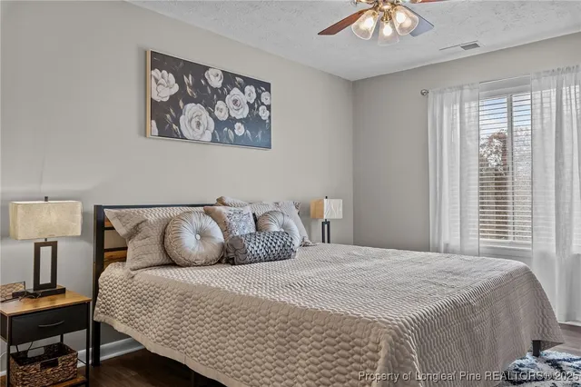 a bedroom with a bed and a lamp on table